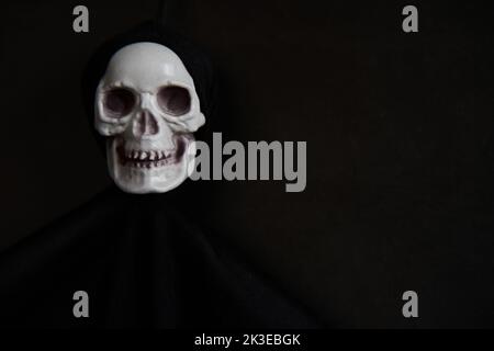 Halloween dark background with skeleton or ghost decoration and place for text Stock Photo