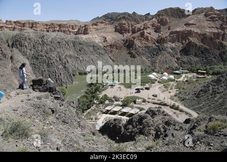 View on base camp with yurts in a valley in Charyn Canyon National Park, Kazakhstan near the river Stock Photo