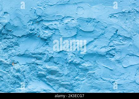 Detail of an old rough wall painted in blue. Surface to place a text. Wallpaper. Stock Photo