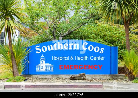 Bandon, OR, USA - September 18, 2022; Blue and white sign for Southern Coos Hospital and Health Center in Bandon Oregon with red emergency information Stock Photo