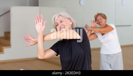 Portrait of an elderly dancing woman practicing vigorous swing Stock Photo