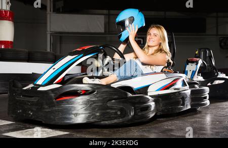 Woman sitting in go-kart car Stock Photo