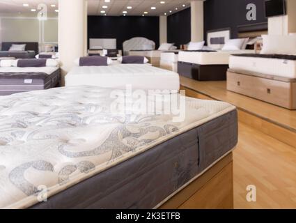 Closeup of new modern orthopaedic mattress on display for sale in large furniture store Stock Photo