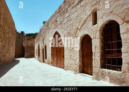 Iron wrought wooden door on a narrow street of Mardin Stock Photo