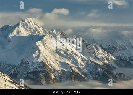 Mountain winter landscape above clouds Stock Photo