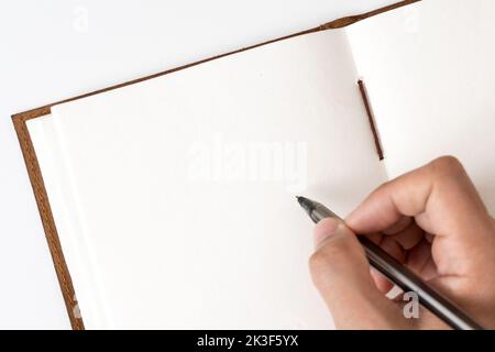 Blank notebook with hand holding pen Stock Photo