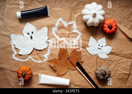 Halloween ghosts from dry maple leaves. Halloween natural DIY decor. Kids art project. Sustainable Eco-Friendly Halloween holiday decoration Stock Photo