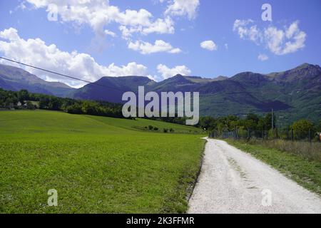 Road with Sibillini Mountains in the background. Stock Photo