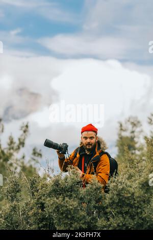 Nature photographer takes pictures in the mountains . Stock Photo