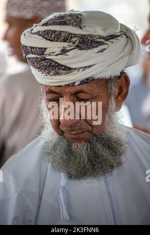 Adult bearded man in traditional wear at the friday morning cattle market, Nizwa, Oman Stock Photo