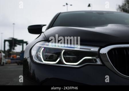 The Front Xenon LED Headlight On A 2018 BMW M5 Competition Pack With Chrome Grille Surrounds Finished In Gloss Black Stock Photo