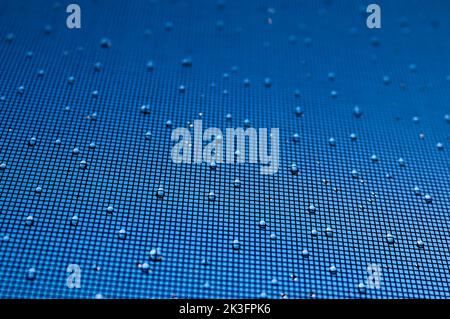 Raindrops on mesh screen Stock Photo
