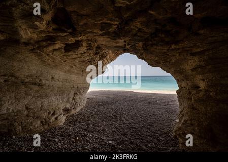 A natural cave in front of Stony Beach, Tiwi, Oman Stock Photo