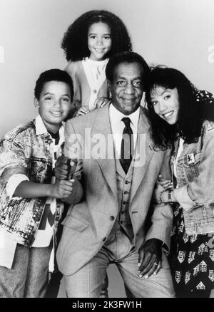 Salim Grant, Brooke Fontaine, Bill Cosby, Kimberly Russell, Publicity Portrait for the Film, 'Ghost Dad', photo by Howard Bingham for Universal Pictures, 1990 Stock Photo