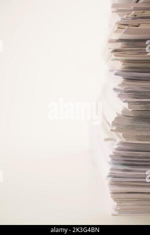 Stacked white paper sheet office documents on white background. Stock Photo