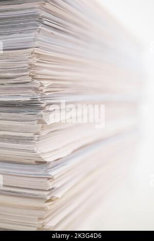 Stacked white paper sheet office documents on white background. Stock Photo