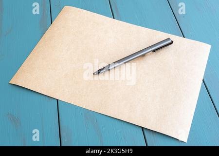 Gray fountain pen on an empty brown paper. Stock Photo