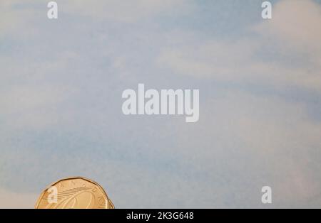 Canadian one dollar coin on blue nuanced background. Stock Photo