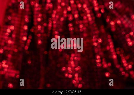 Red bokeh blurred background. Red festive background with glitter for romance, love and Valentine's day concepts. Stock Photo