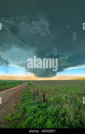 The formation of a mesocyclone is a prelude to a tornado, forming off of a dirt road and a remote area on Oklahoma. Stock Photo