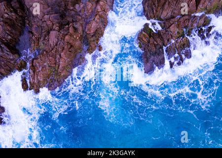 An Amazing Shot Of Rocky Beach With Splashing Sea Waves Crashing 