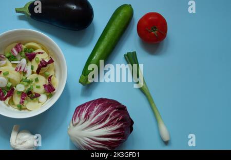 Flat lay of various vegetables on blue background Stock Photo