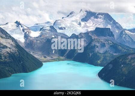 Mt. Garibaldi towering over Garibaldi Lake's beautiful glacial blue water. Stock Photo