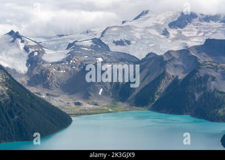 Mt. Garibaldi towering over Garibaldi Lake's beautiful glacial blue water. Stock Photo