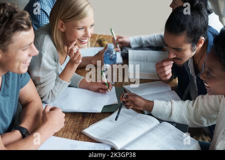 You mean it wont be in the quiz. A group of college students sitting together and studying. Stock Photo