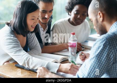 Your methodology blows my mind. A group of college students sitting together and studying. Stock Photo