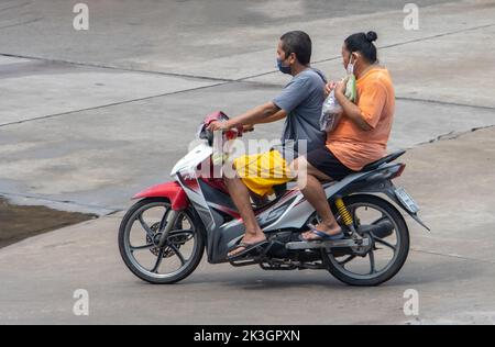 SAMUT PRAKAN, THAILAND, SEP 23 2022,  The pair rides on motorcycle at the street. Stock Photo