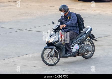 SAMUT PRAKAN, THAILAND, SEP 23 2022, A man with backpack rides a motorcycle Stock Photo