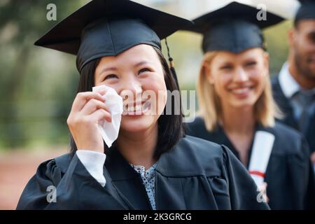 Filled with a sense of accomplishment. An ecstatic young graduate shedding tears of joy at her graduation. Stock Photo
