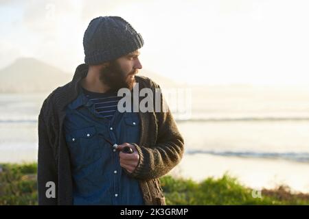 Smoking a pipe. a bearded man smoking a pipe outside. Stock Photo