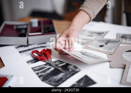 Working hard on her creative vision. A young woman working withe negatives. Stock Photo
