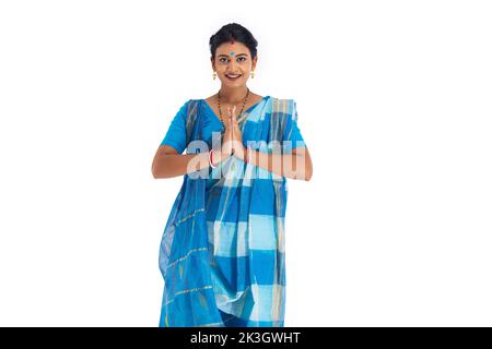 Portrait of Bengali housewife greeting against white background Stock Photo