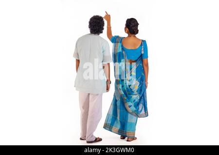 Back view of Bengali couple standing against white background Stock Photo