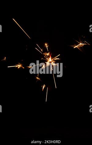Sparkler with sparks on black background for overlay blending mode for holiday design projects Stock Photo