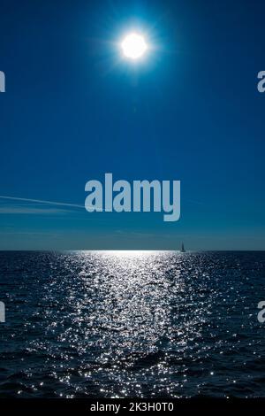 abstract colored beautiful horizon background mit sun and water and sailing boat Stock Photo