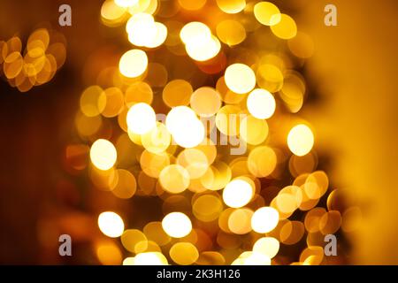 Warm golden festive christmas garland lights blurred background Stock Photo