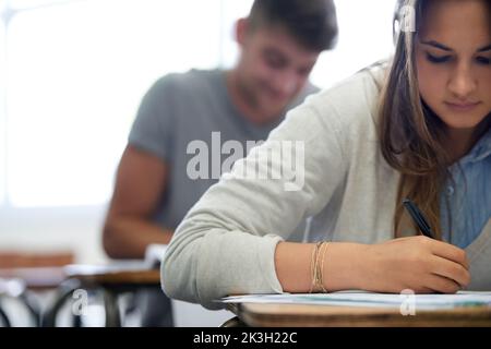 Working towards their future. young college students hard at work in class. Stock Photo