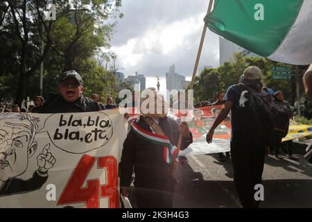 Mexico, Mexico. 26th Sep, 2022. A protester disguises himself of Mexican President Andres Manuel Lopez Obrador seen during a demonstration to commemorate the 8th anniversary of the disappearance of the 43 Ayotzinapa students. On the night of September 26, 2014, 43 students from the Raœl Isidro Burgos Rural Normal School located in Iguala, Guerrero, were victims of forced disappearance by members of public security from the state of Guerrero and federal military security.The students had allegedly tried to hijack trucks to use for their protests. Credit: SOPA Images Limited/Alamy Live News Stock Photo