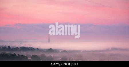 Salisbury Cathedral in the autumn early morning mist from the ramparts of Old Sarum Wiltshire south west England UK Stock Photo