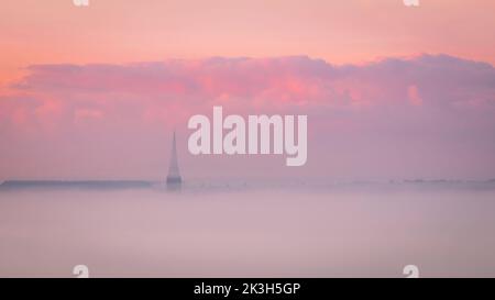 Salisbury Cathedral in the autumn early morning mist from the ramparts of Old Sarum Wiltshire south west England UK Stock Photo