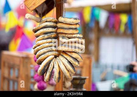 Bagels on a wooden stump. Bunch of freshly baked bread rolls. Stock Photo