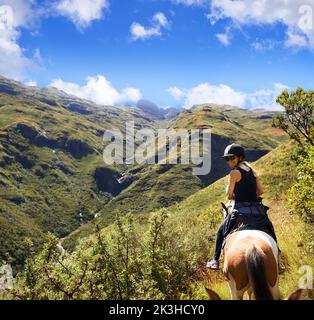 Horse riding in the outback. an attractive young woman riding a horse. Stock Photo