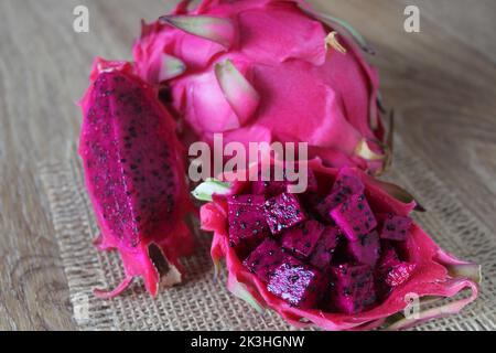 Dragon fruit, cut purple dragon fruit or pitaya known as ‘ejder meyvesi’ in Turkish. Close up, sitting view. Stock Photo