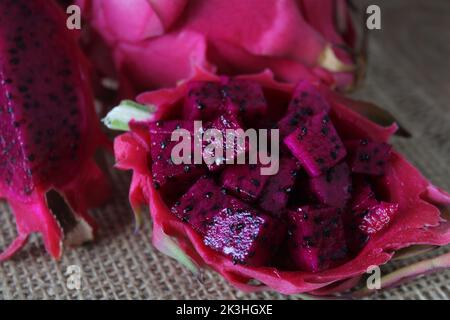 Dragon fruit, cut purple dragon fruit or pitaya known as ‘ejder meyvesi’ in Turkish. Close up, sitting view. Stock Photo