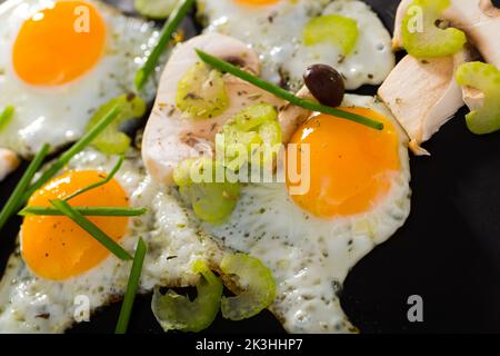 Fried quail eggs with champignons Stock Photo