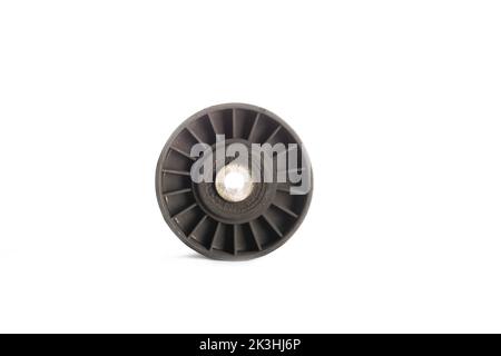 Old dirty car roller made of plastic and bearing on a white background. Close-up Stock Photo